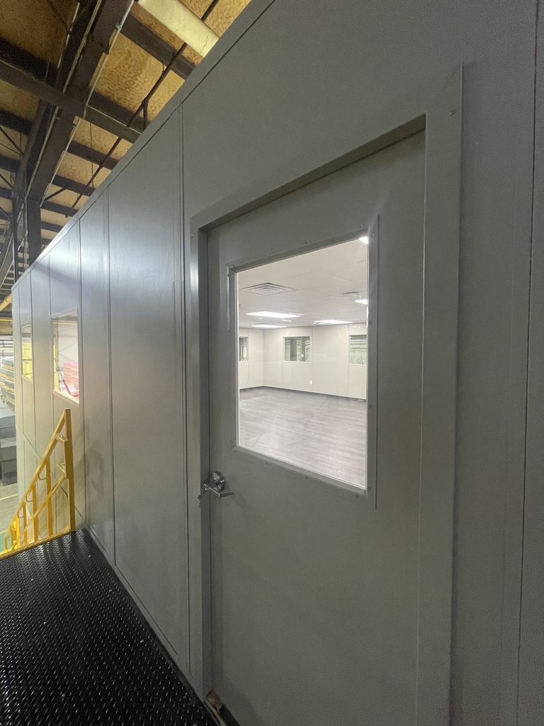Second-floor modular office installation inside a manufacturing facility
